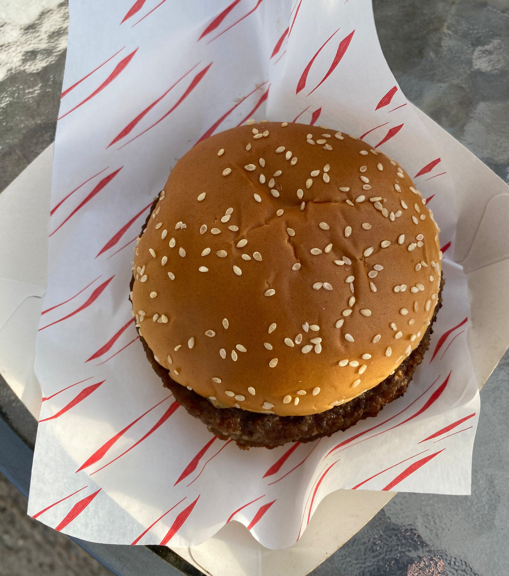 A sesame-seed beef burger in red-and-white greaseproof paper at Pack Meadow, Coleshill